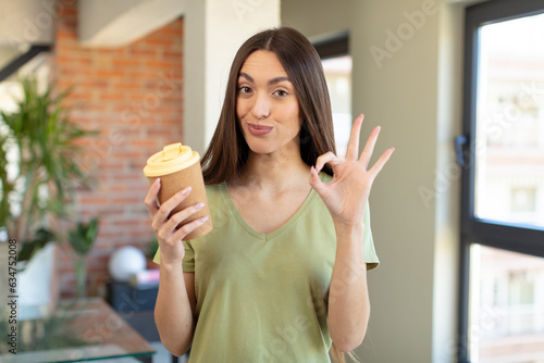 feeling happy, showing approval with okay gesture. take away coffee concept