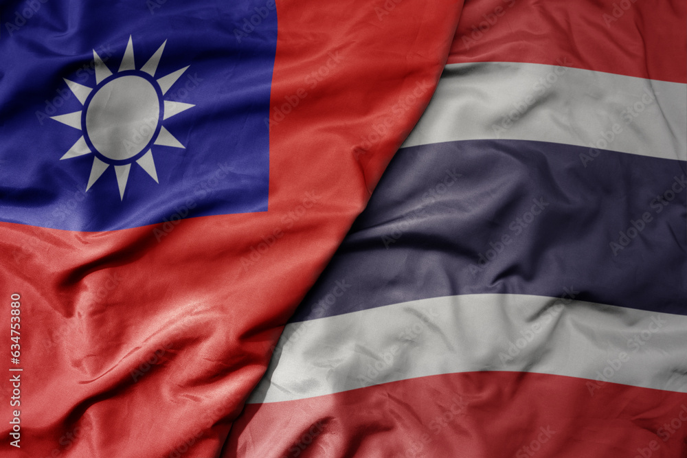 big waving realistic national colorful flag of taiwan and national flag of thailand .