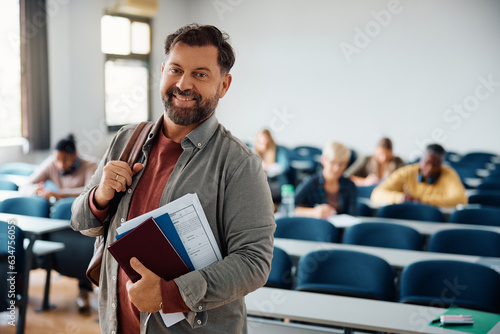 Happy mature student in lecture hall looking at camera. photo