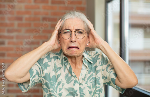 senior pretty woman feeling stressed, worried, anxious or scared, with hands on head, panicking at mistake