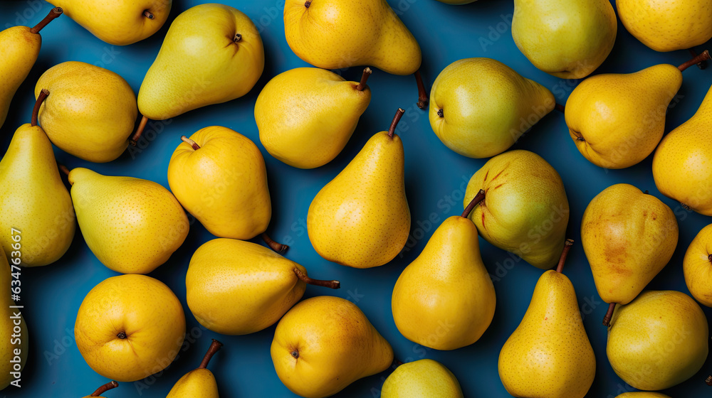 several yellow-green pears on a blue background. healthy vitamin rich food concept.