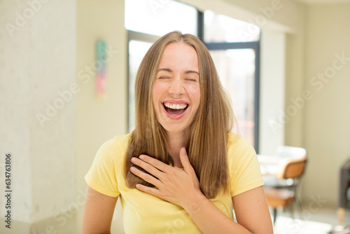 Free Download pretty blond woman laughing out loud at some hilarious joke, feeling happy and cheerful, having fun - GFXLoad