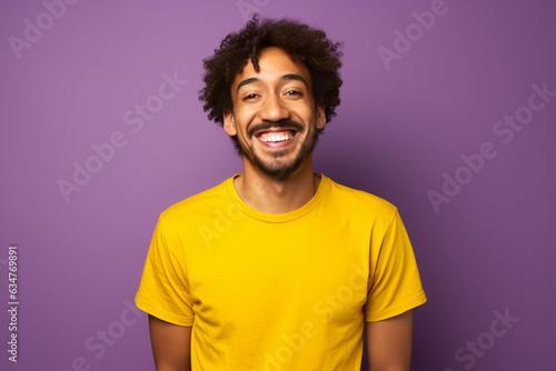 a man dressed in yellow t shirt is smiling against a background © toonsteb