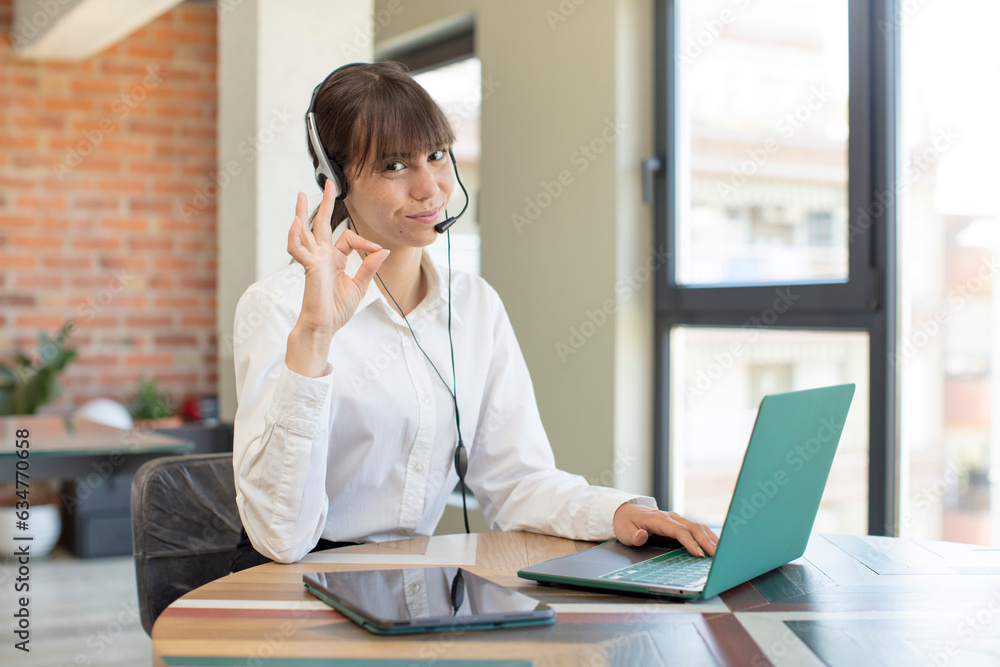 young pretty woman feeling happy, showing approval with okay gesture. telemarketer concept young pretty woman feeling happy, showing approval with okay gesture. telemarketer concept