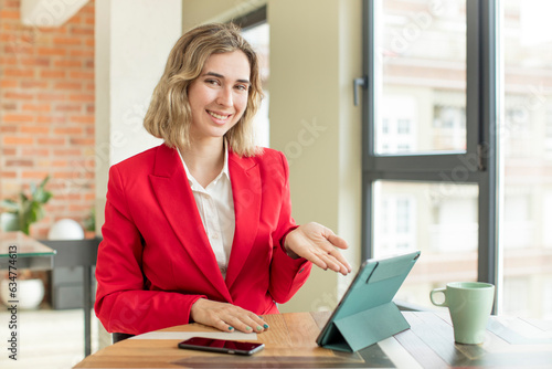 pretty woman smiling cheerfully, feeling happy and showing a concept. touch screen pad concept