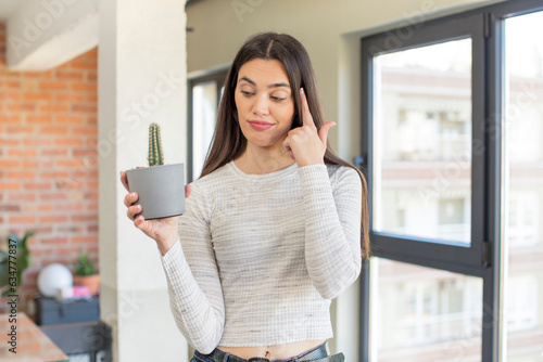 pretty young model looking surprised, realizing a new thought, idea or concept. decorative cactus concept Free Download pretty young model looking surprised, realizing a new thought, idea or concept. decorative cactus concept - GFXLoad