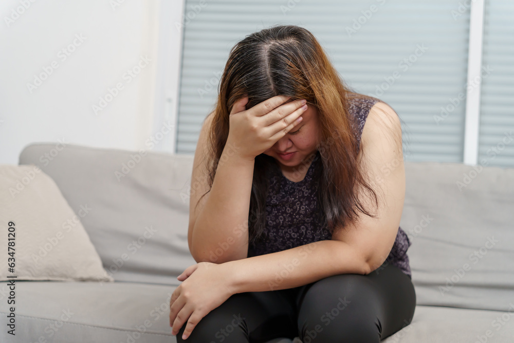 Sad Overweight plus size woman thinking about problems on sofa upset girl feeling lonely and sad from bad relationship or Depressed woman disorder mental health Sad Overweight plus size woman thinking about problems on sofa upset girl feeling lonely and sad from bad relationship or Depressed woman disorder mental health