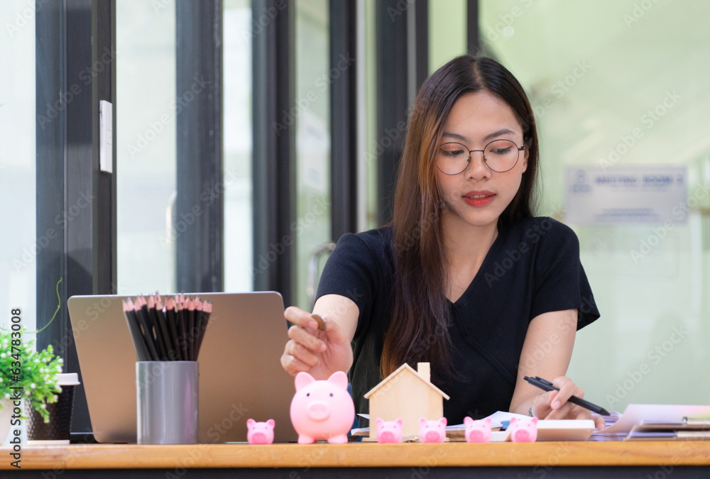 Businesswoman using calculator calculate budget about house contract mortgage in the office room Businesswoman using calculator calculate budget about house contract mortgage in the office room