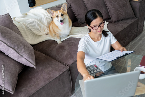 Woman casually working at home office.