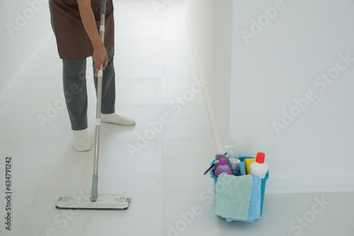 Woman  housewife mopping floor at home.