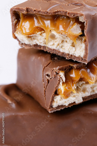 Chocolate bar with caramel fillings. Sweet chocolate bar broken into two pieces. Macro shot.