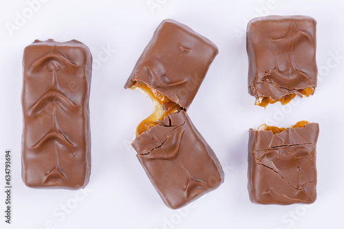 Whole, fracture and broken into two pieces chocolate bars. Top view.