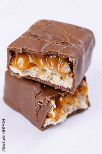 Chocolate bar with caramel fillings. Sweet chocolate bar broken into two pieces.