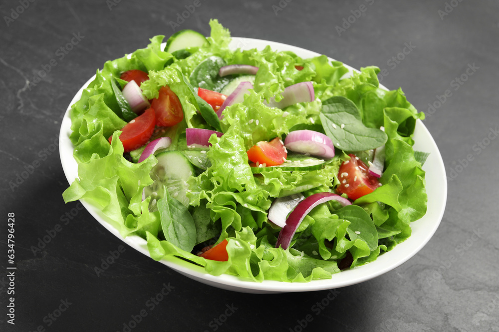 Delicious salad in bowl on grey table, closeup Delicious salad in bowl on grey table, closeup