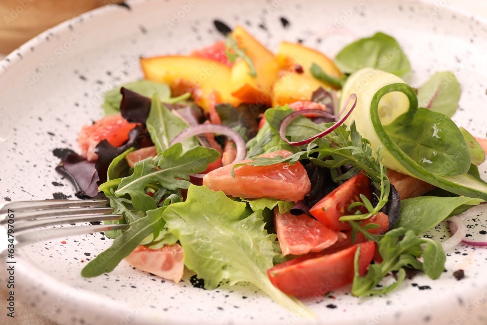 Delicious salad with vegetables and peach in bowl, closeup Delicious salad with vegetables and peach in bowl, closeup