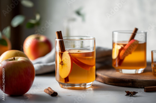 Papier peint Homemade Apple Cider with cinnamon sticks and apple slices served in two glasses with fresh red apples on background