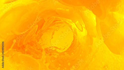 Splashing orange juice creating twister shape.