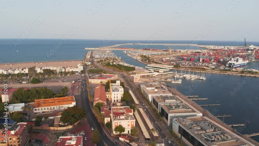 Flight over the port and beach of Valencia. Top-down view of yachts and docks. Sunset over the horizon. 4K. Flight over the port and beach of Valencia. Top-down view of yachts and docks. Sunset over the horizon. 4K.