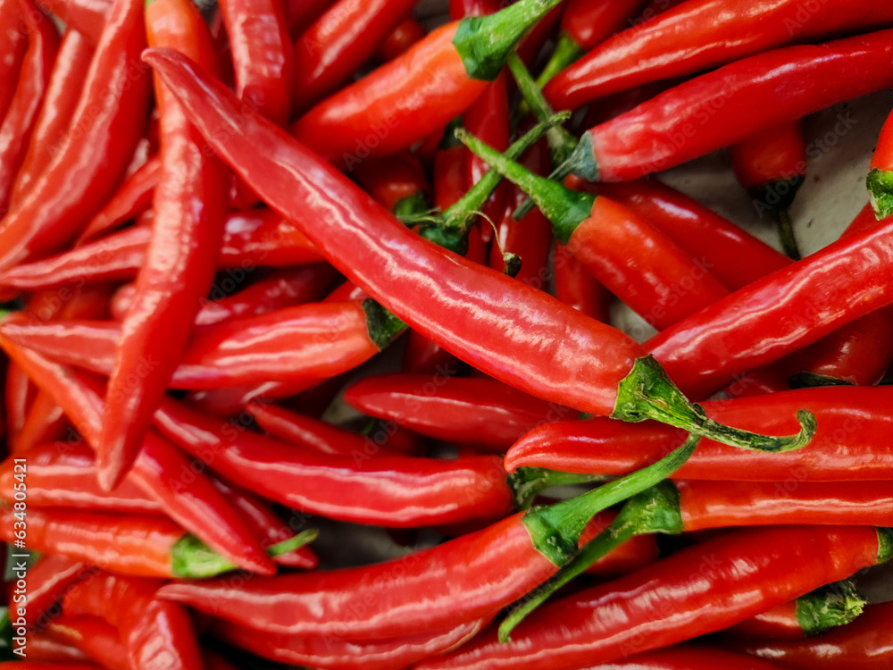 large of fresh red chilies on display in the supermarket or grocerie store