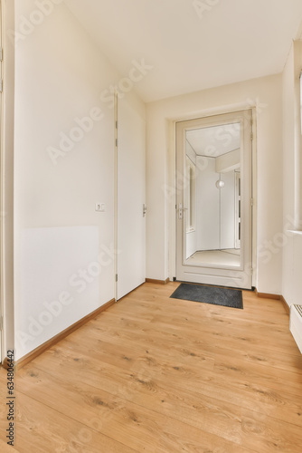 Wallpaper Mural an empty room with wood flooring and white walls on either side of the room, there is a large mirror in the corner Torontodigital.ca