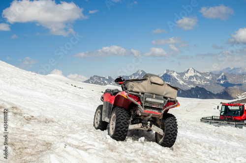 ATV on snow in the mountains.an extreme adventure.quad bike.