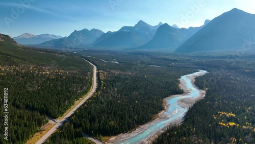 Canada. A drone view of the river in the mountains valley. An aerial view of a forest. Winding river among the trees. Turquoise mountain water. Landscape at the day time.