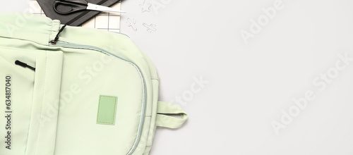 School backpack and different stationery on white background with space for text