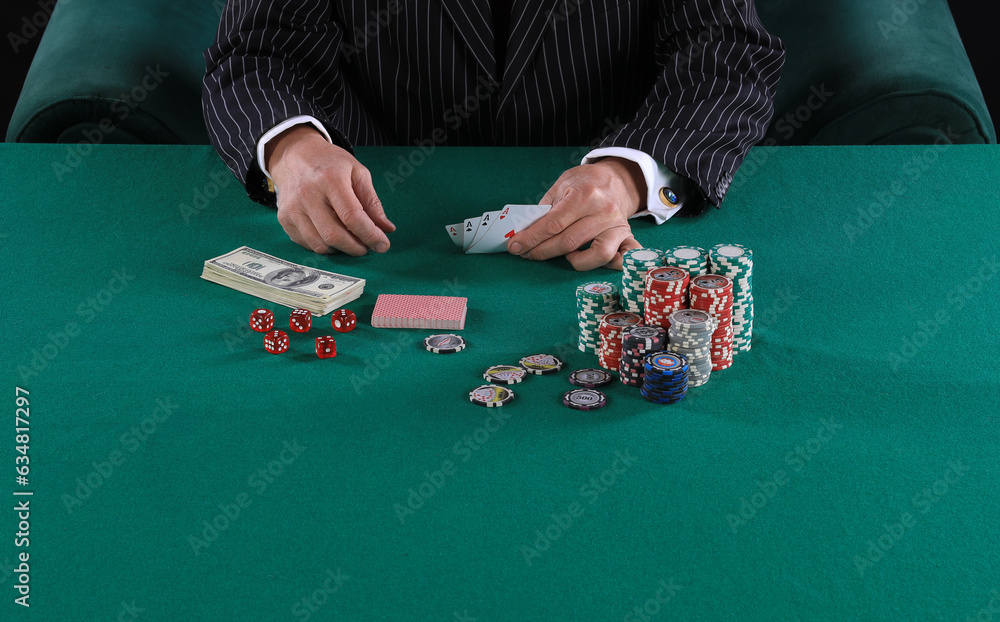 hands of a poker player on a green card table hands of a poker player on a green card table