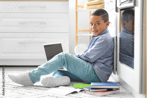 Smiling schoolboy sitting o...