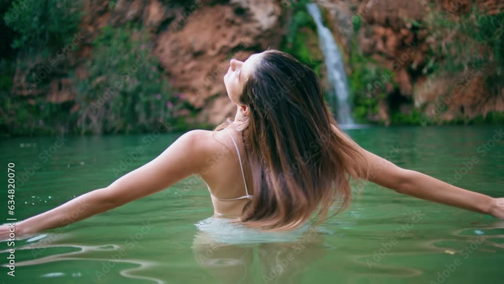 Sensual girl shaking hair resting tropical nature back view. Lady looking camera Sensual girl shaking hair resting tropical nature back view. Lady looking camera