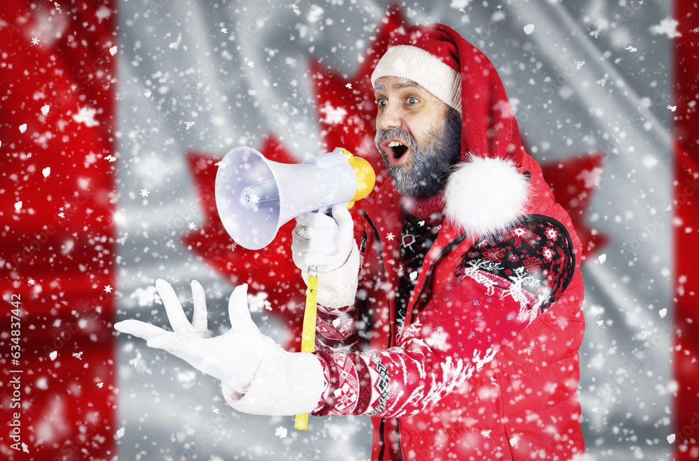 Santa Claus shouts into a megaphone and shows a hand gesture against the background of the flag of Canada Santa Claus shouts into a megaphone and shows a hand gesture against the background of the flag of Canada