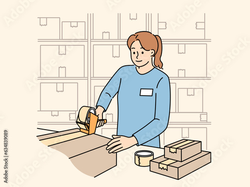 Woman works in warehouse packing parcels and sealing cardboard boxes while performing duties as storekeeper. Girl employee of warehouse or point of issue of orders stands near racks with cardboxes
