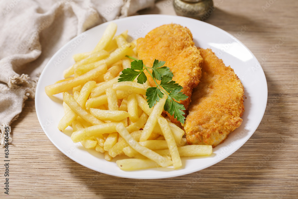plate of chicken schnitzel with french fries
