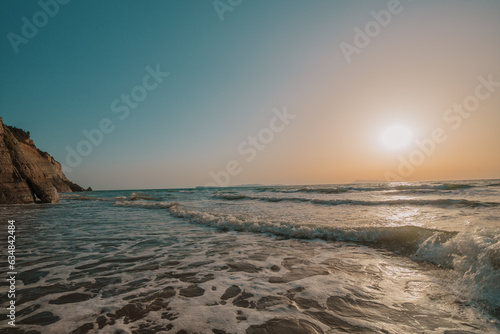Idyllic shot of sea with sunset sky in background