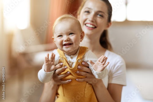 Portrait of happy smiling cute baby and mother at home