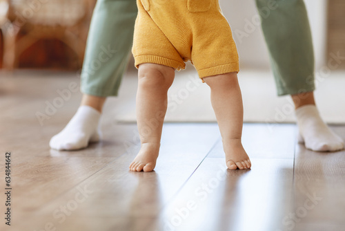Little baby kid child learn walking in home with mother