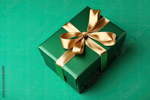 Gift box with golden satin ribbon and bow on green background. Generative AI