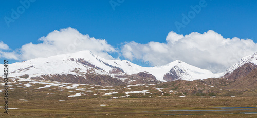 Snow-covered mountains and lakes on Barskoon road to Kumtor. Kyrgyzstan