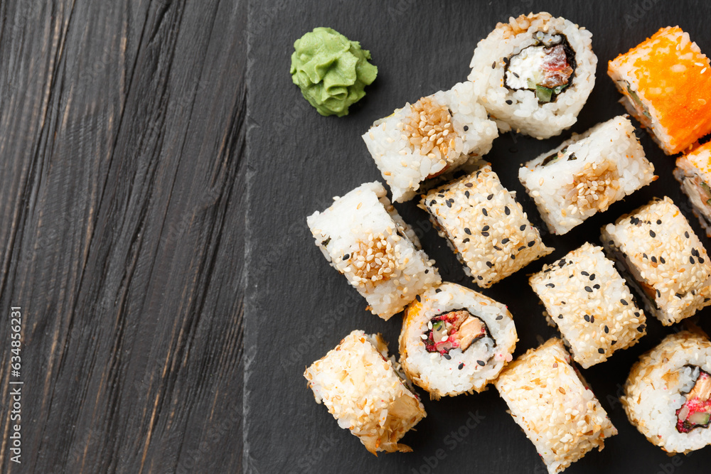 Set of various sushi rolls on a black slate plate, close-up. Set of various sushi rolls on a black slate plate, close-up.