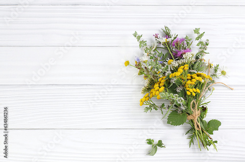 Floral arrangement of wild herbs and flowers , autumn background, Bouquet of tansy, mint, celandine, chamomile and yarrow, collection of useful herbs for treatment according to folk recipes.