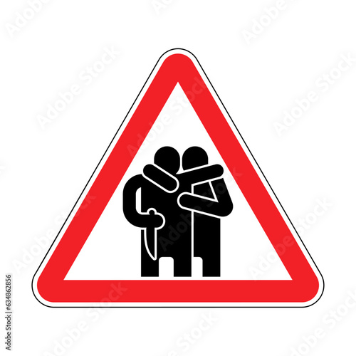 Attention traitor. Caution of betrayal. Red triangular road sign. Concept of betrayal is a knife in the back.