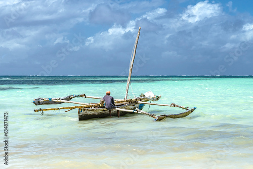 old fishing boat on the beach of kenya africa photo