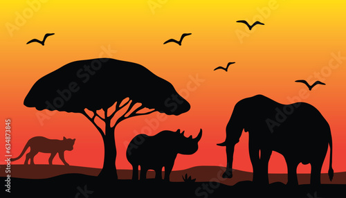 Silhouette of animals and trees in a savanna during the evening, against an African background.