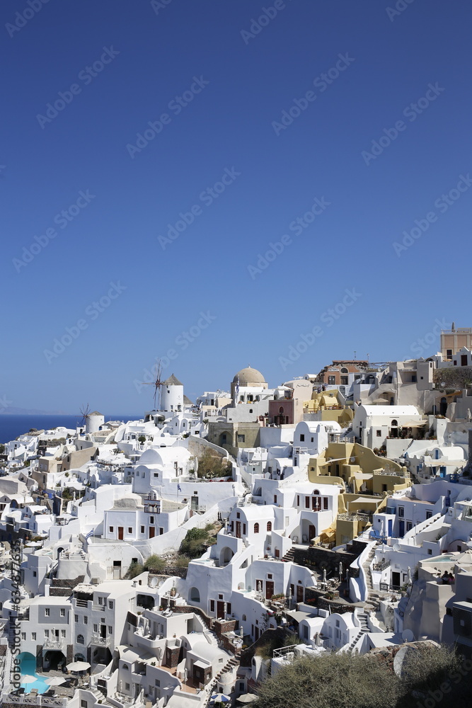 Many white houses in a cliff in Oia, Santorini, Greek Islands Many white houses in a cliff in Oia, Santorini, Greek Islands