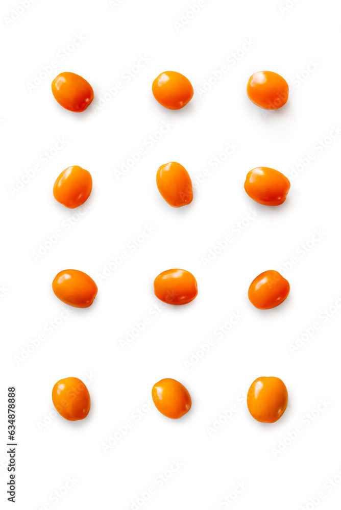 Closeup of fresh juicy organic orange cherry tomatoes from the garden on isolated white background from above