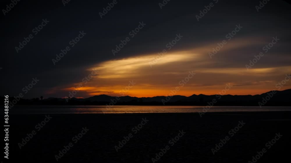 Dark shore silhouette during summer dusk. A view of dark summer sky during sunset on the beach silhouette. Dark shore silhouette during summer dusk. A view of dark summer sky during sunset on the beach silhouette.