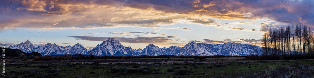 Panorama of the snow covered Teton Mountain range with heavy cloud cover in Grand Teton National Park, Wyoming, USA  
