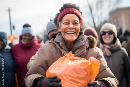 Positive homeless woman with plastic bag full of clothes