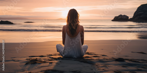 Harmonious connection  Meditating woman on beach back view  horizon over the sea. Creative wallpaper with woman meditating in lotus pose in nature. 