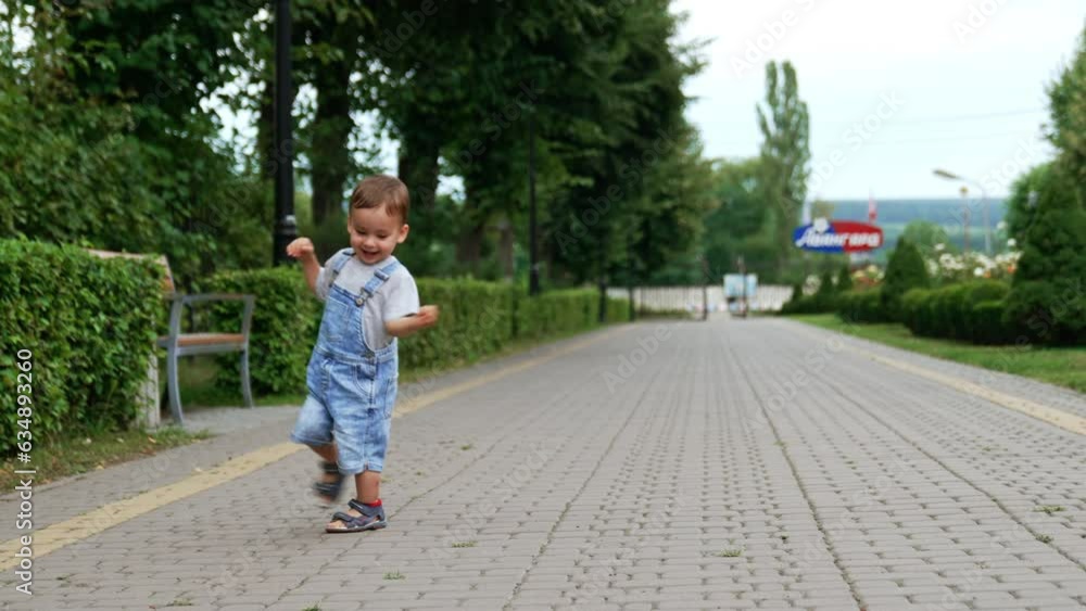 Happy Caucasian kid running circles in the park. Healthy active child having fun outdoors in summer. Happy Caucasian kid running circles in the park. Healthy active child having fun outdoors in summer.